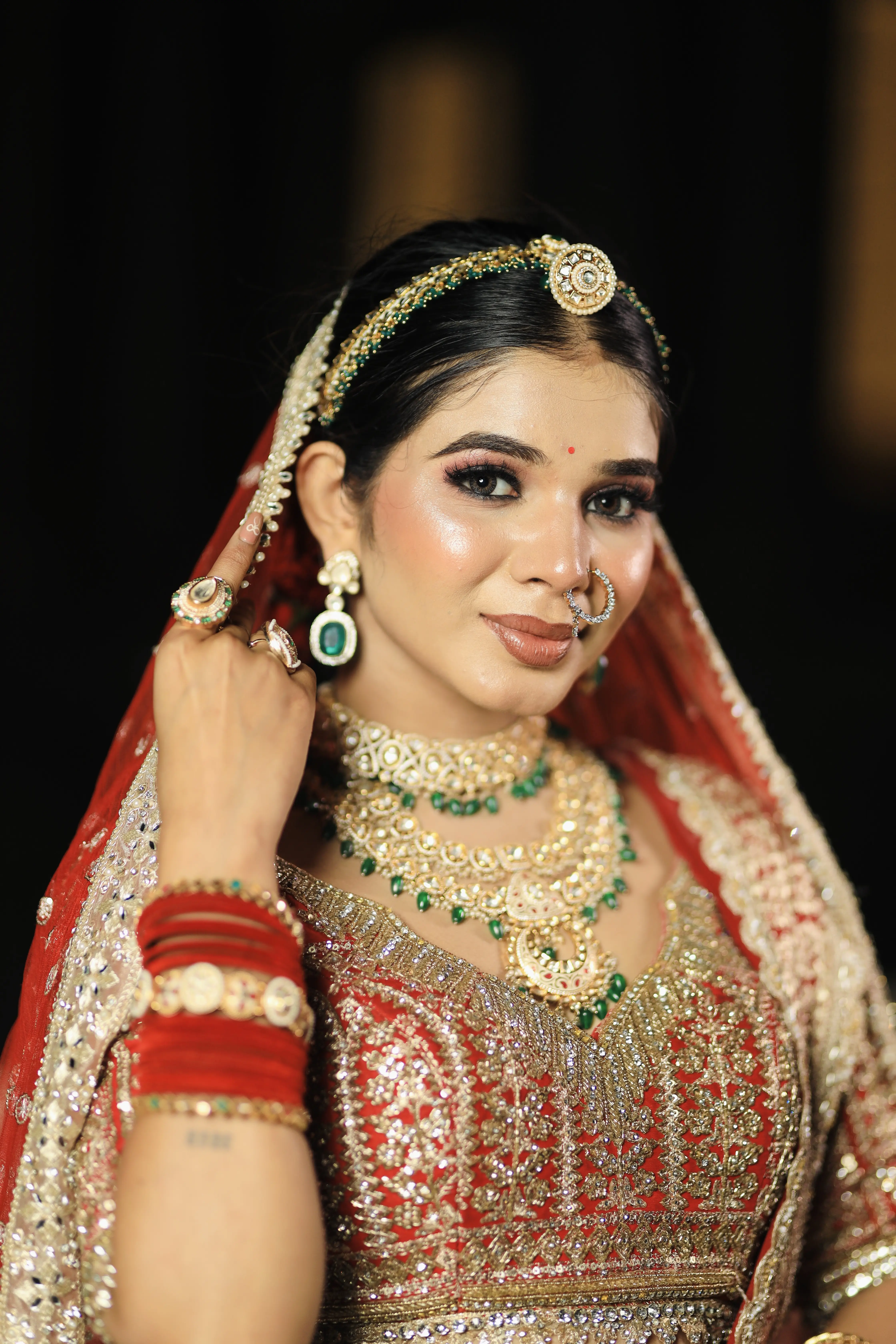Bridal makeup with bold eyes and soft curls at 7 Mirrors Salon Nagpur